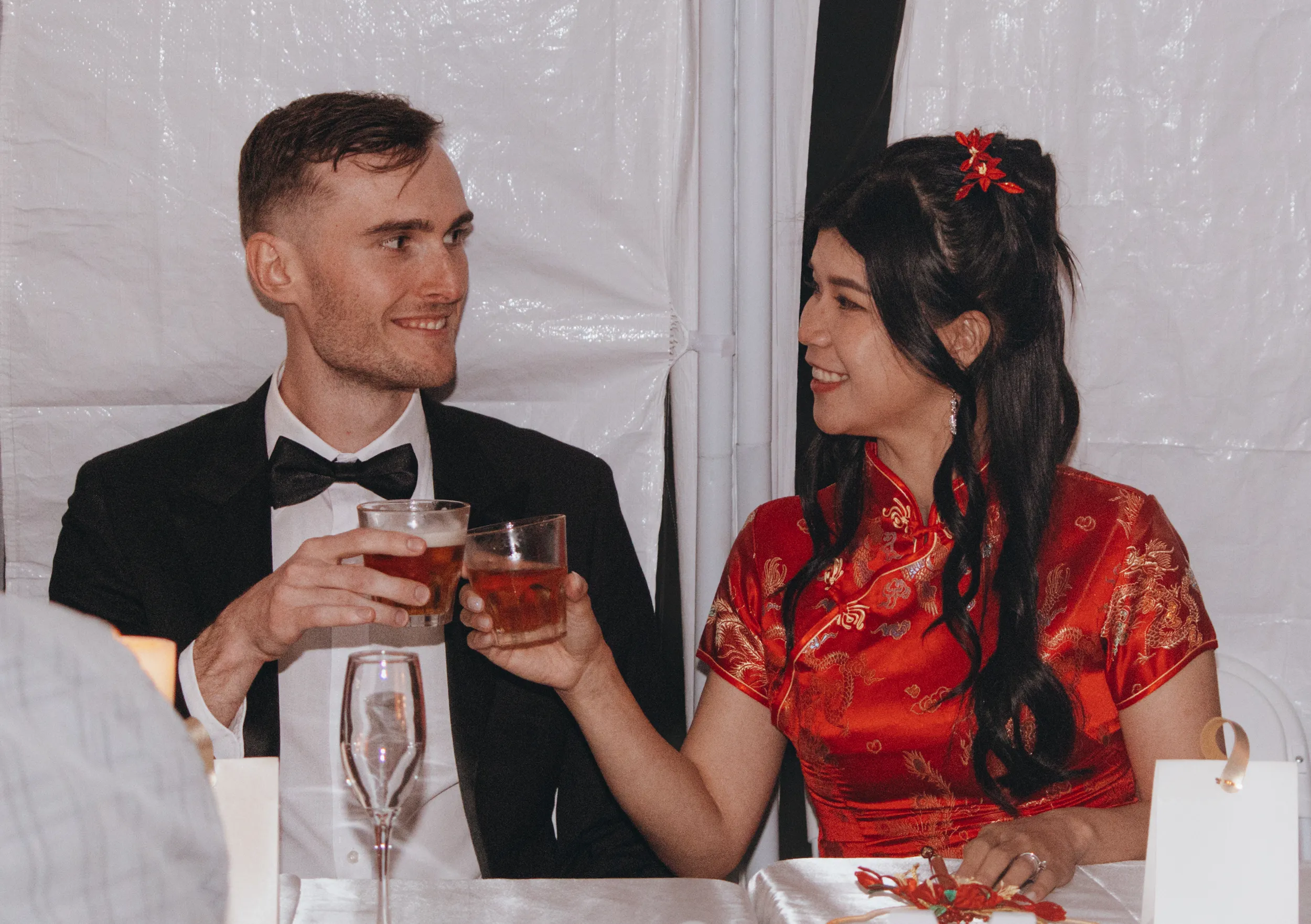 Huiyu and Chris intimate reception toast with bride in red qipao and groom in tuxedo